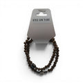 CCBeadsandBeyondLLC brown wooden beaded bracelet with evil eye charm and accent beads.