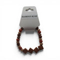 CCBeadsandBeyondLLC Diamond Rush bracelet with red, brown, and tan beads and square carved charms.
