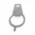 CCBeadsandBeyondLLC Feminine N Fancy pink and grey beaded bracelet with crown charm.
