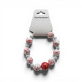 CCBeadsandBeyondLLC peppermint themed bracelet with white and red swirled beads and smaller white beads.